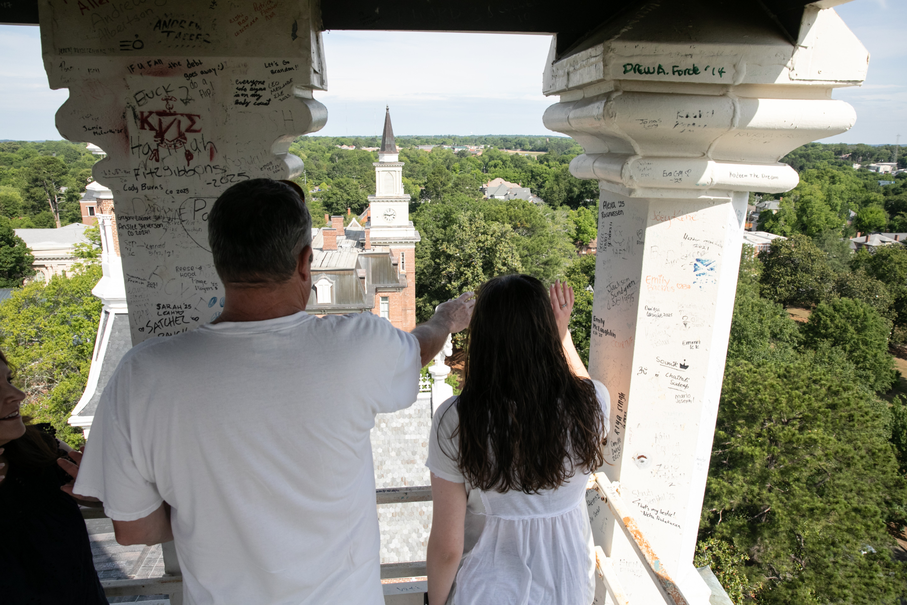 Two people look out the tower of the Godsey Administration Building.