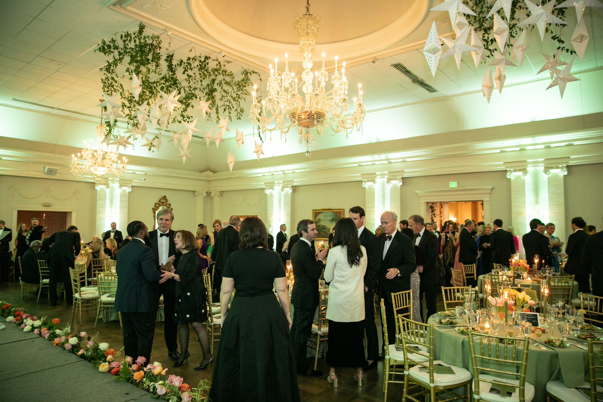 People mingle in a ballroom.