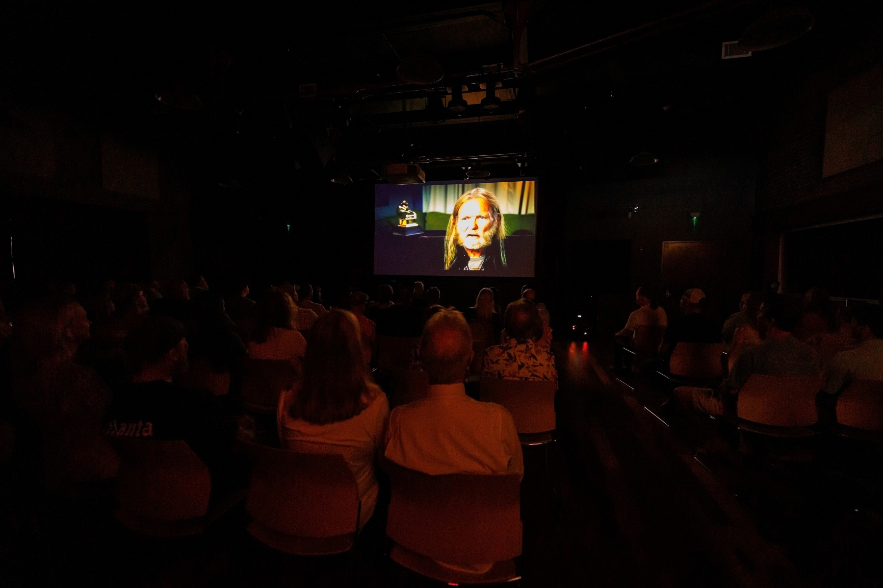 People watch the Gregg Allman documentary at Mercer Music at Capricorn.