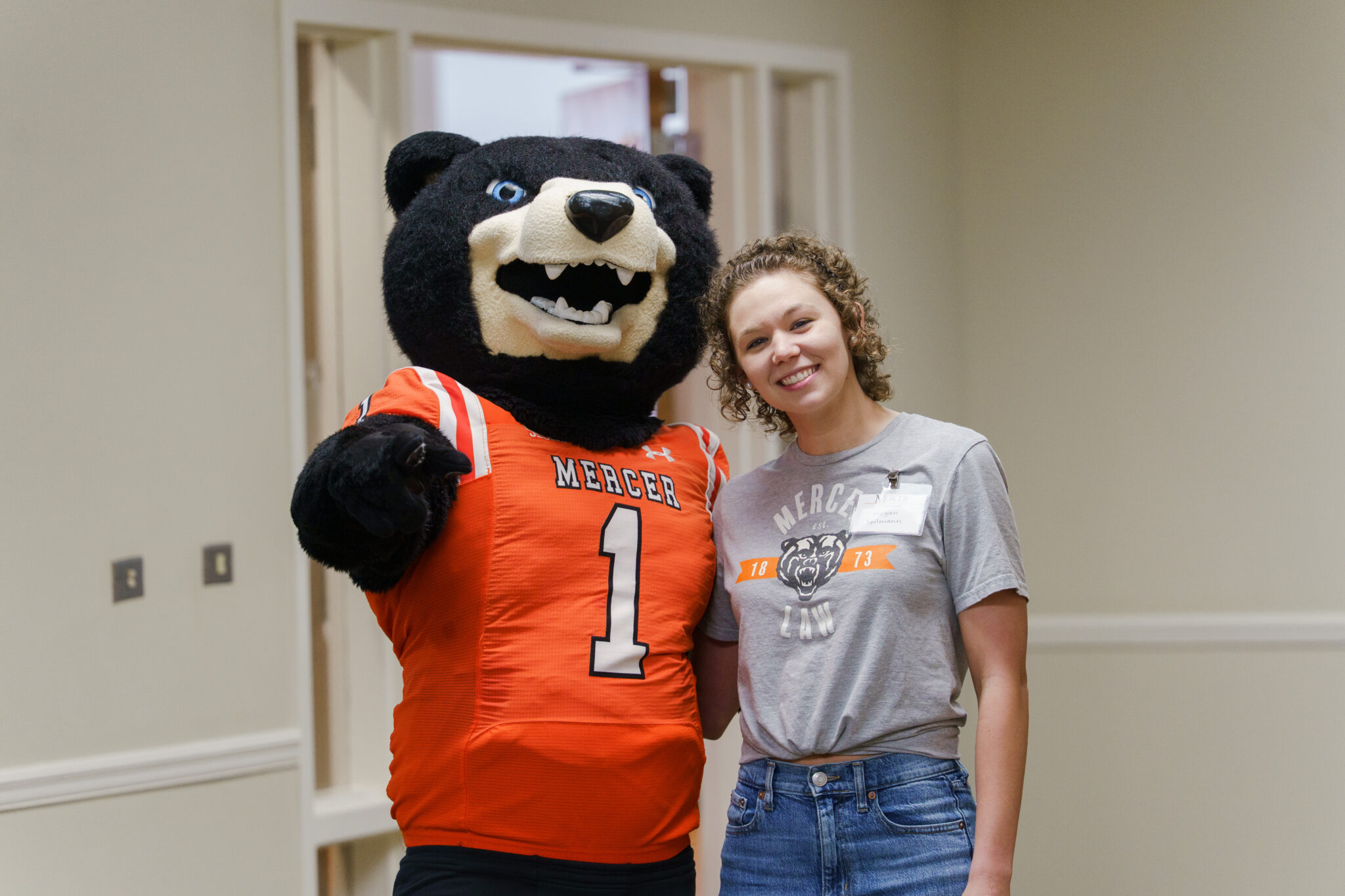 Mercer Bears mascot Toby and a law student.