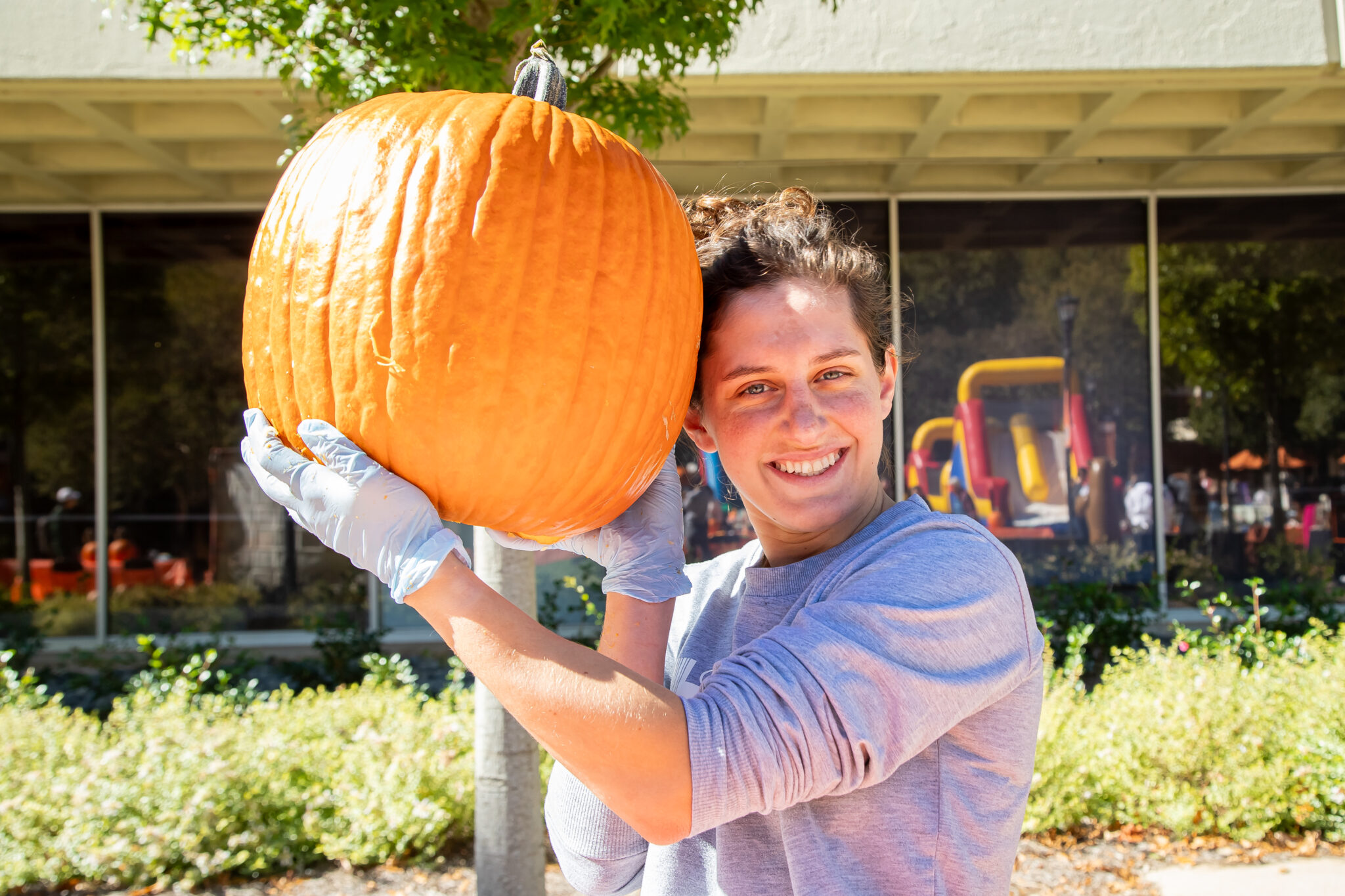 Person holding a pumpkin.