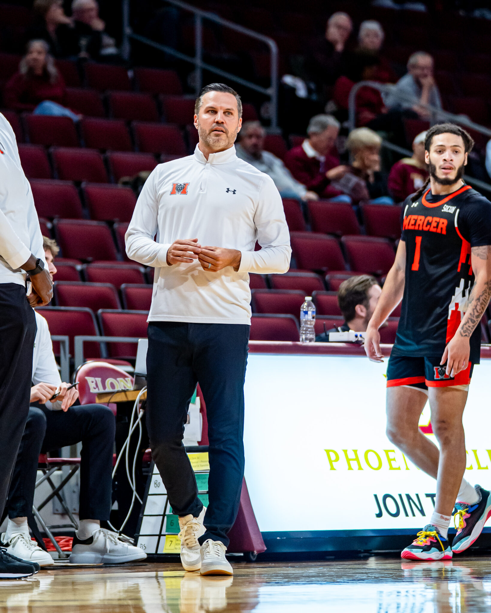 Mercer men's basketball coach Ryan Ridder on the court during a game.