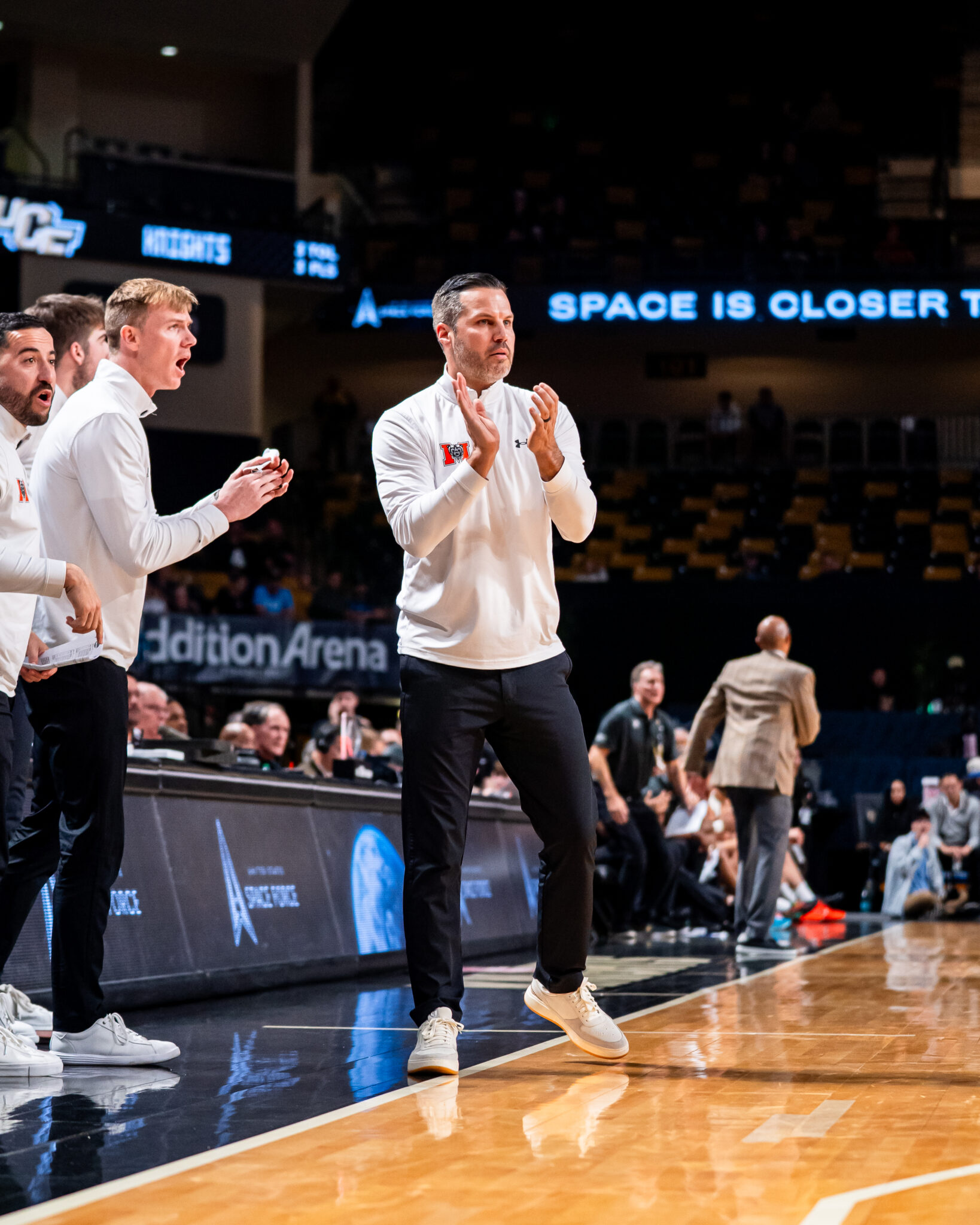 Mercer men's basketball coach Ryan Ridder on the court during a game.