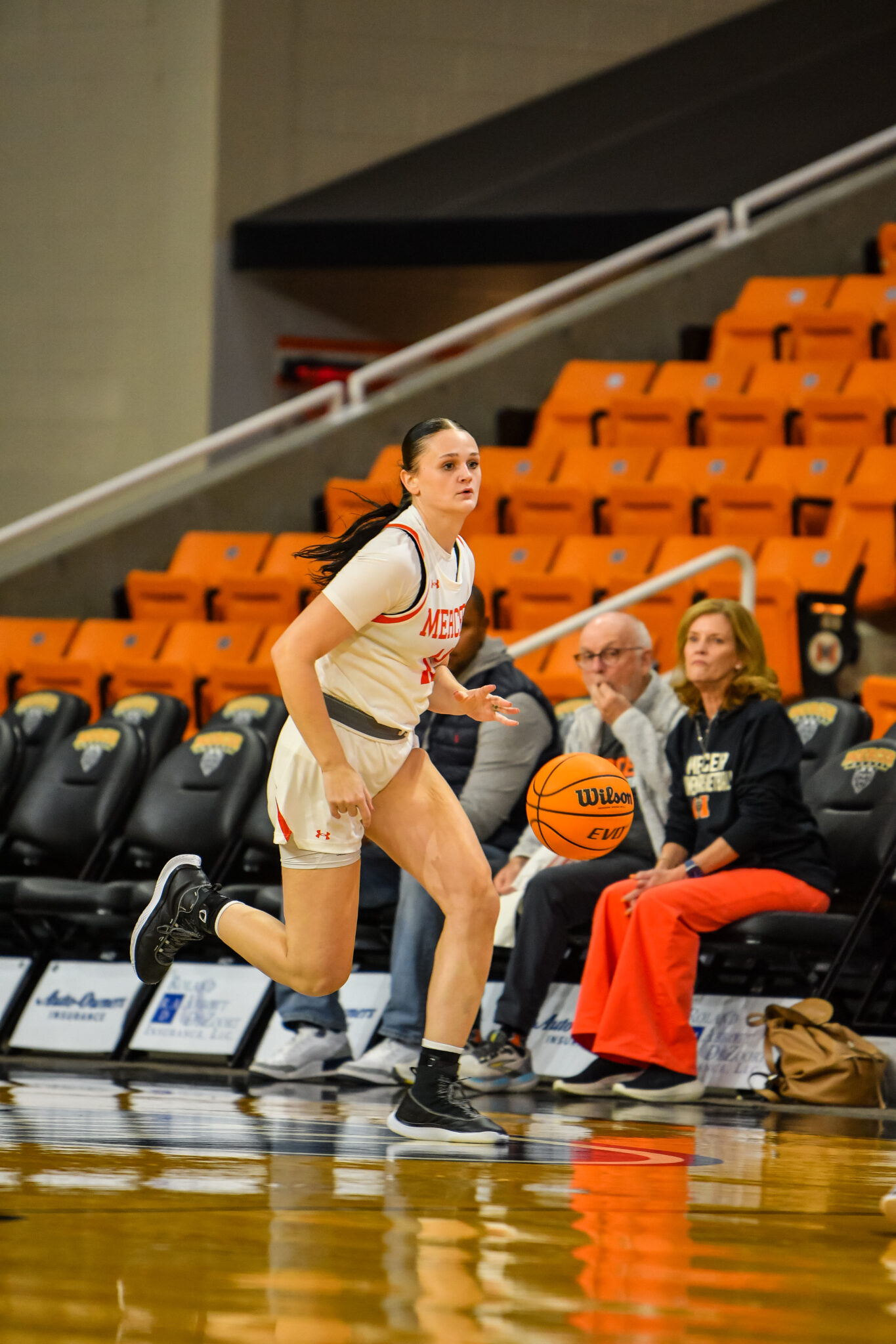 A Mercer women's basketball player dribbles the ball during a game.