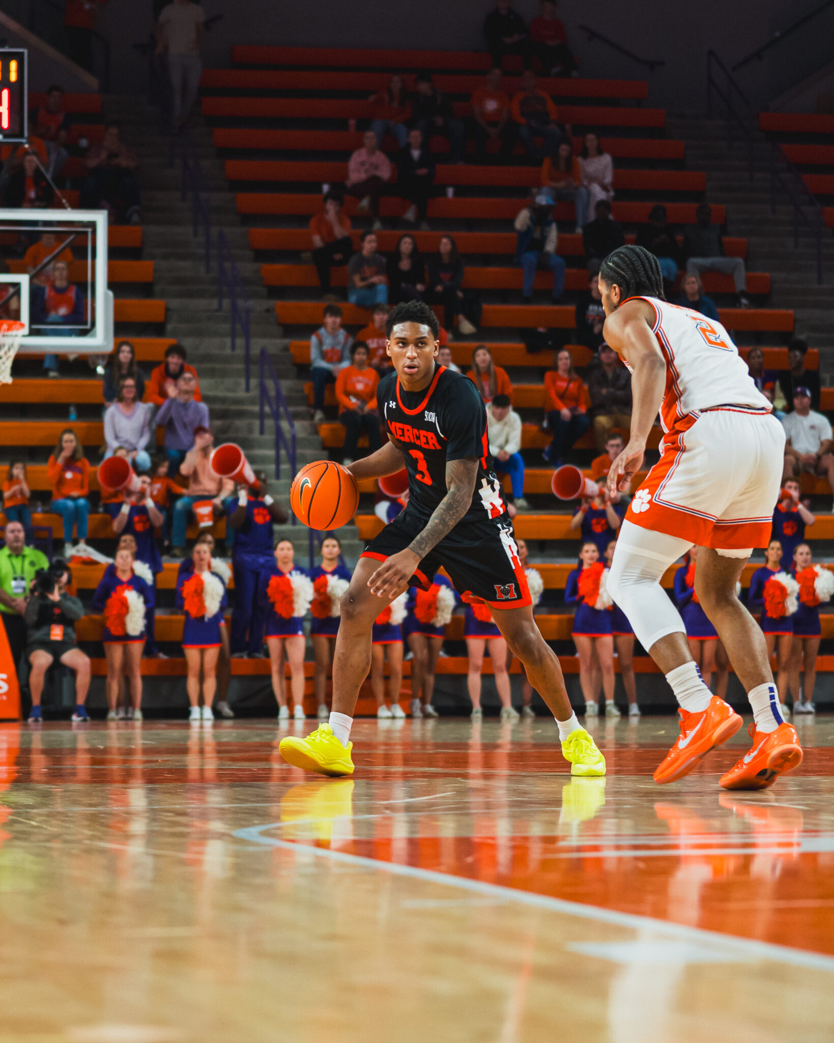 A Mercer men's basetball player dribbles the ball during a game.
