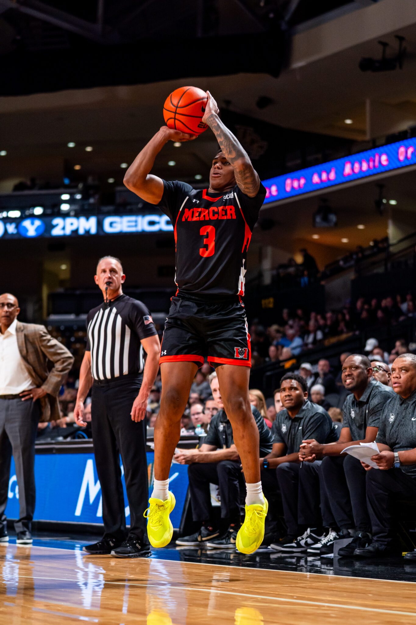 A Mercer men's basketball player shoots the ball during a game.