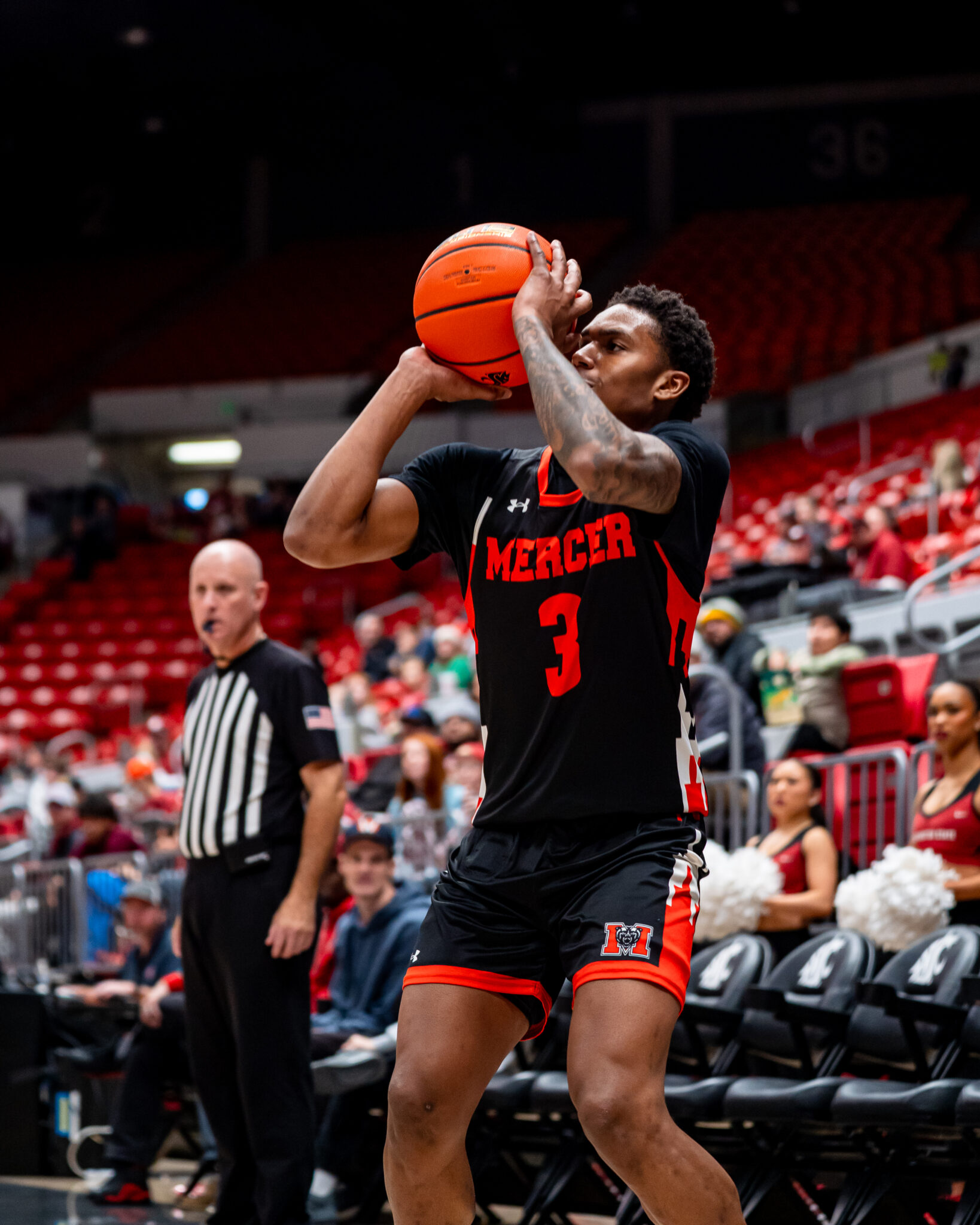 A Mercer men's basketball player shoots the ball during a game.