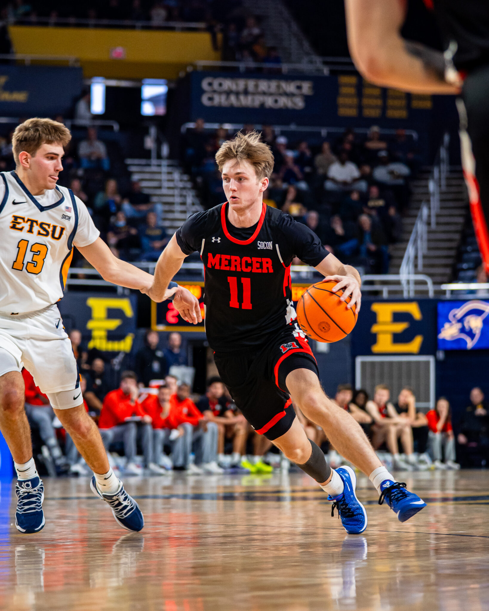 Mercer men's basketball player dribbles the ball during a game