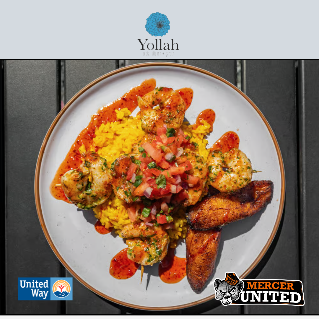 A plate of shrimp, yellow rice and sweet plantains.